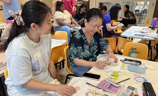 Participants making art together at a community workshop